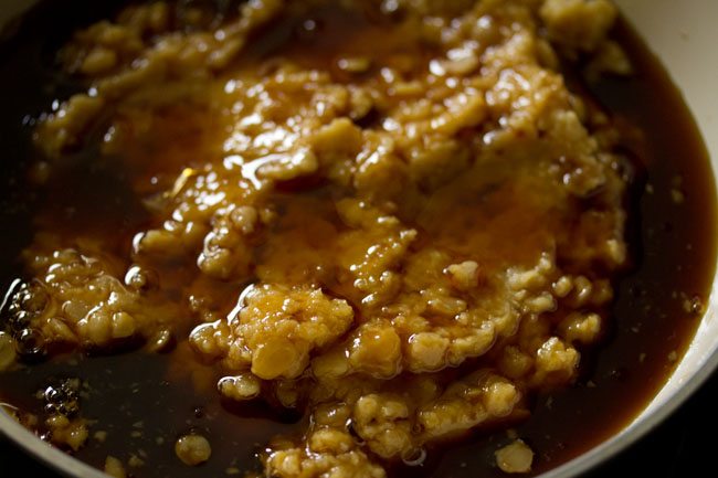 filtered jaggery syrup added to the mashed chana dal. 