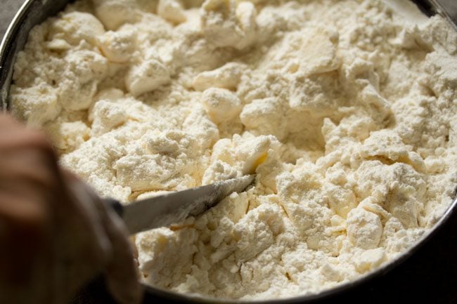 cutting butter into flour for puff pastry recipe.