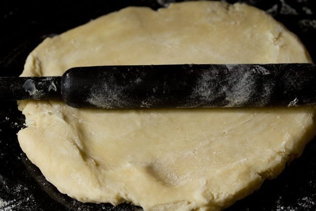 rolling dough for preparing rough puff pastry recipe.