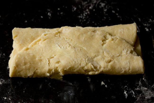 folding the bottom third of the pastry to overlap the first fold.