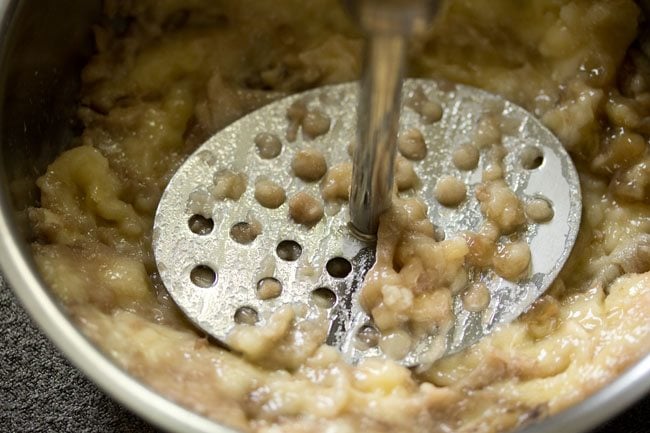 bananas being mashed to make eggless banana pancakes