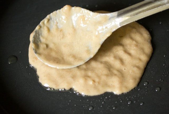 banana pancake batter being spread on the pan