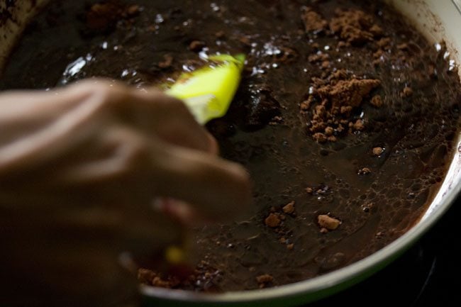 mixing ingredients to make cocoa solution for eggless brownie. 