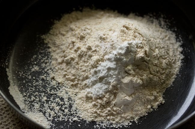 whole wheat flour, baking powder and salt added to a bowl. 