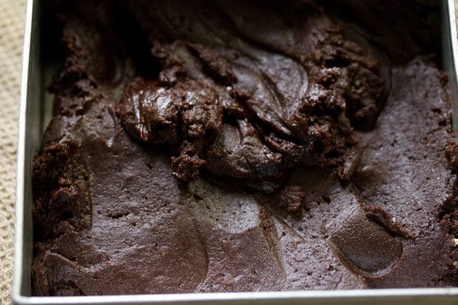 brownie batter added to prepared baking pan. 