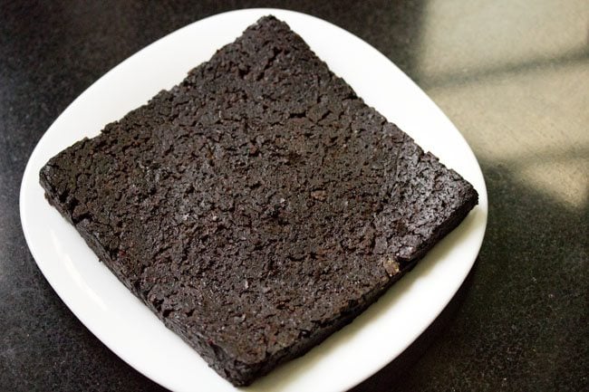 brownie slab placed on a white plate. 