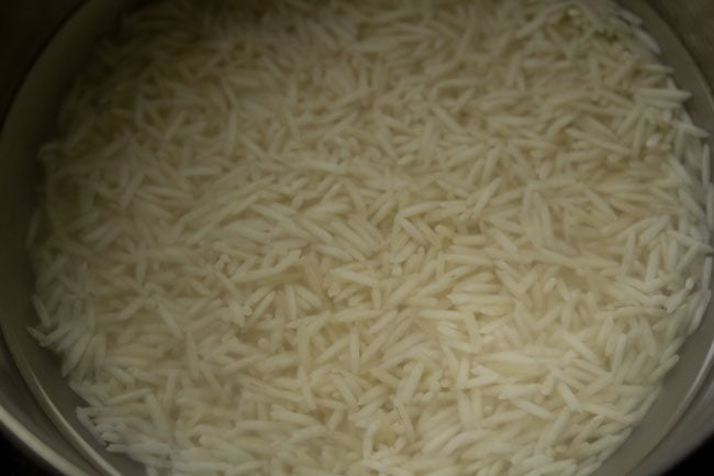 soaked rice in water in a pan