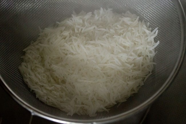 straining rice in a colander