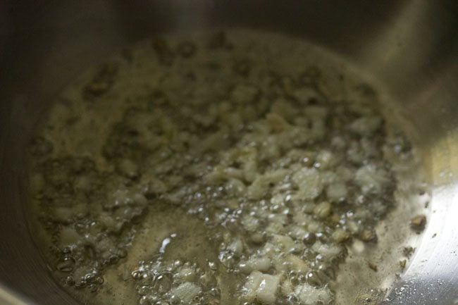 stir fry the garlic in the wok