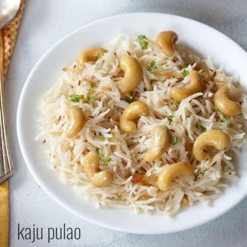 kaju pulao served on a white plate.