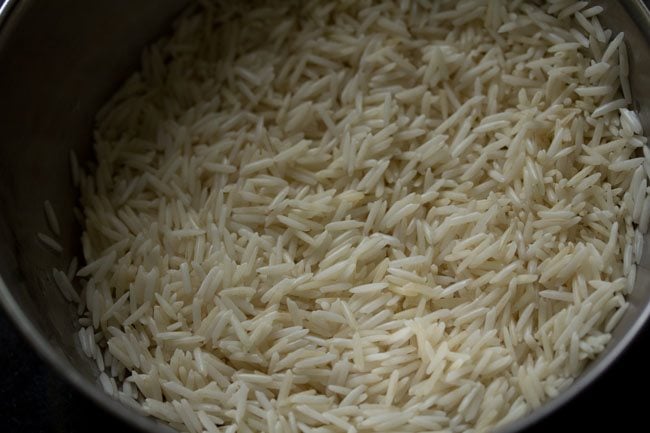 soaking basmati rice for kaju pulao. 
