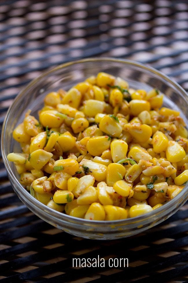 masala corn served in a glass bowl with text layover.