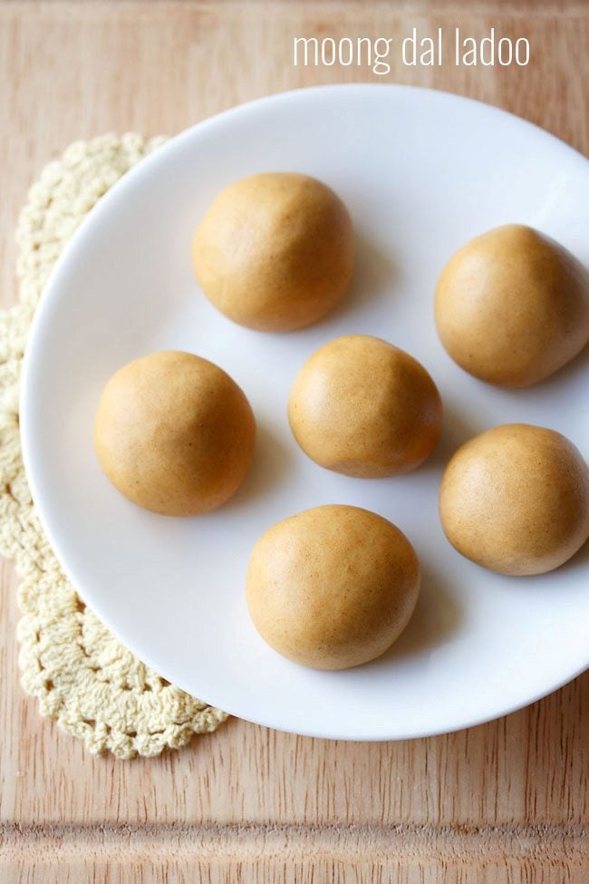 moong dal laddu served on a white plate with text layovers.