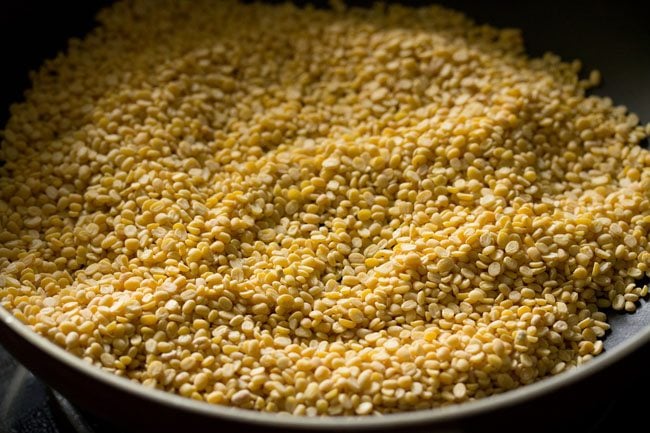 roasting moong dal in pan. 