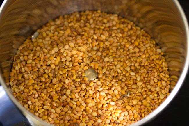 roasted moong dal added to a grinder jar. 