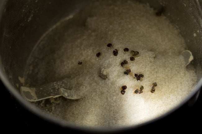 sugar and cardamom seeds added to the grinder jar. 