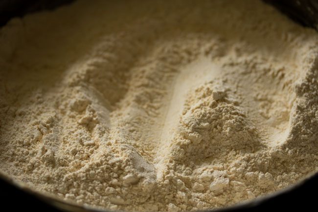 powdered sugar mixed well with the sifted moong dal flour. 