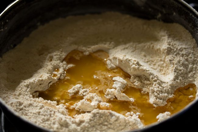 melted ghee added to the moong dal flour-sugar mixture. 