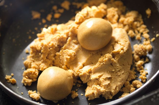 two ladoos shaped from the moong dal mixture. 