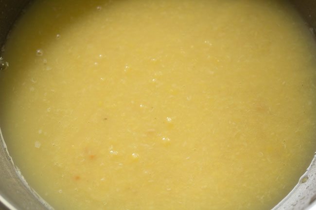 Add thin coconut milk to mashed moong dal to make pasi paruppu payasam. 