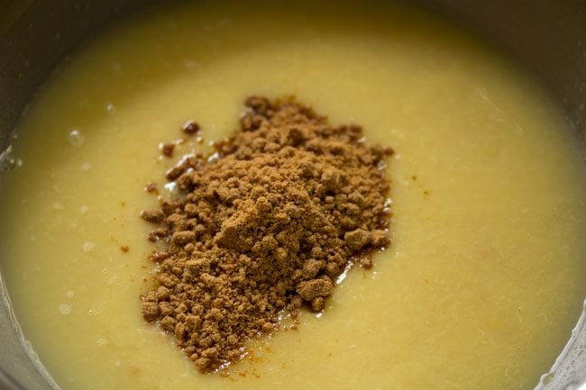 Add jaggery powder to the mashed moong dal. 