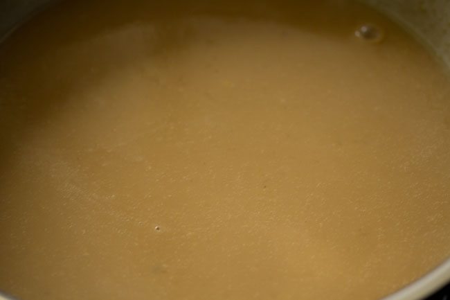 gently heating the moong dal mixture.