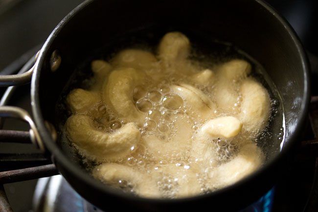 frying cashews in hot coconut oil.