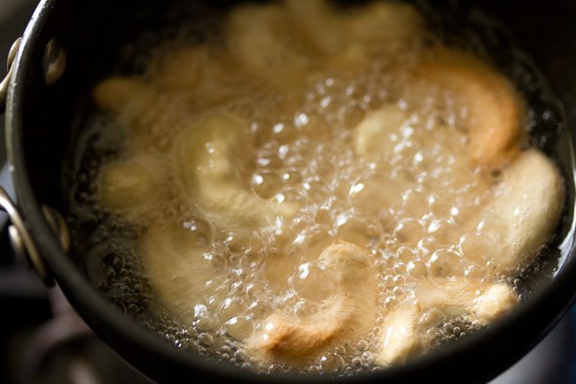 frying cashews in hot coconut oil till golden. 