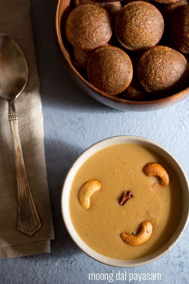 pasi paruppu payasam garnished with fried cashews and served in a white bowl.