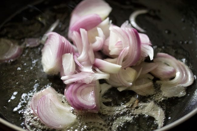 thinly sliced onions added to the pan. 