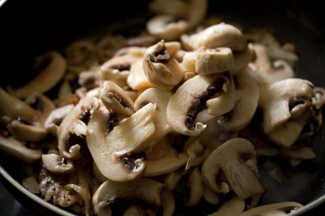sliced mushrooms added to the pan. 