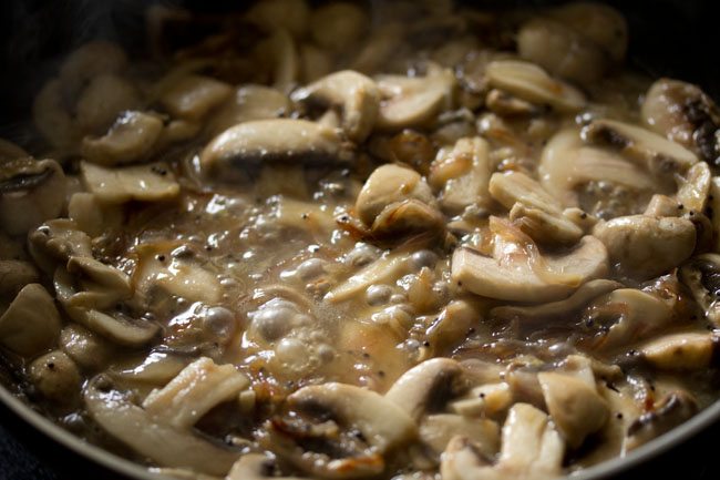 sautéing mushrooms releasing water. 