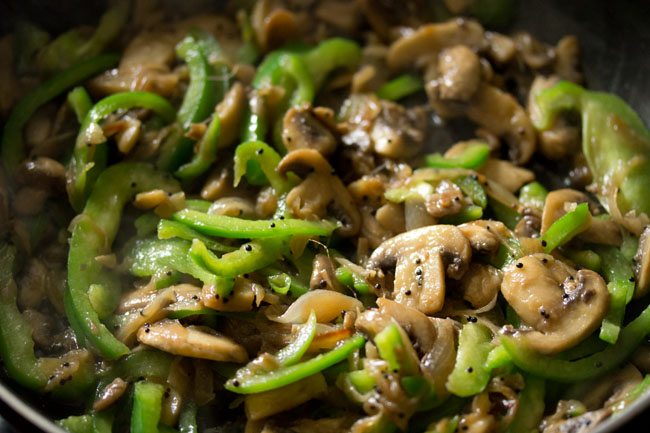 cooking capsicum slices with the mushroom. 