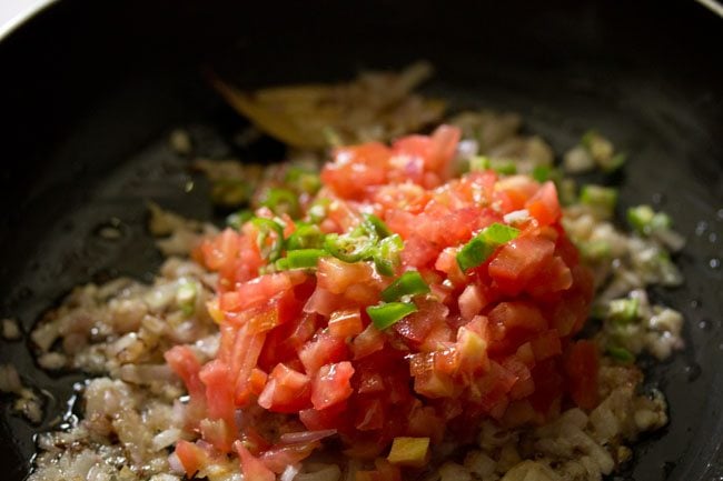 finely chopped tomatoes and finely chopped green chilies added to onions. 