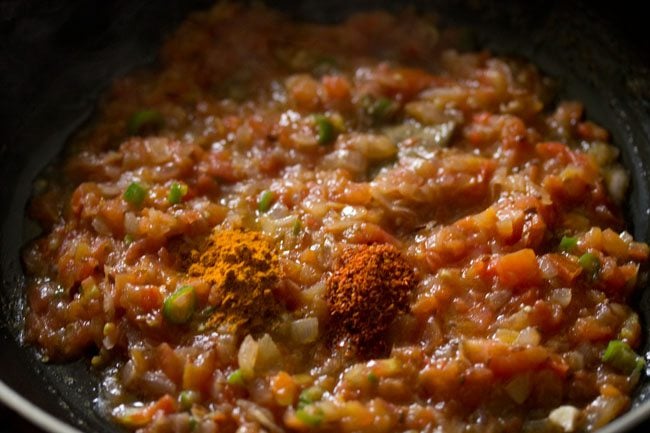 spice powders added to onion-tomato mixture. 