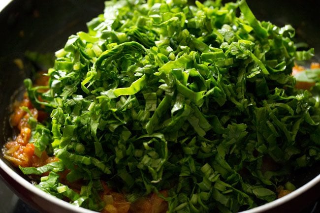 chopped spinach leaves added to onion-tomato masala. 