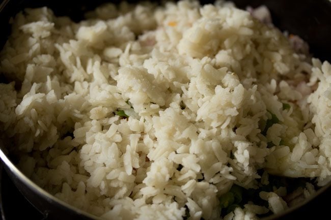 drained poha added to the potato-vegetable mixture. 