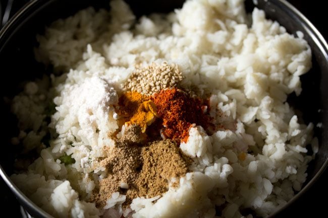 spice powders, white sesame seeds, sugar and salt added to the poha-vegetable mixture. 