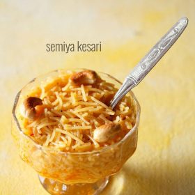 semiya kesari served in a glass bowl with a spoon inside it and text layover.
