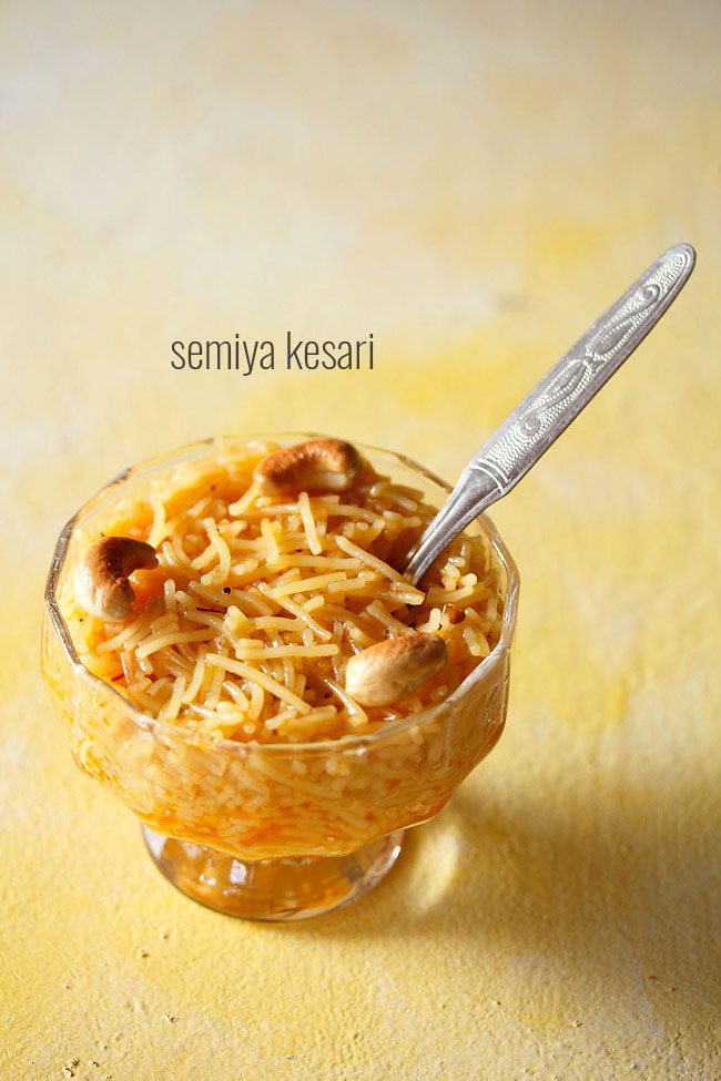 semiya kesari served in a glass bowl with a spoon inside it and text layover.