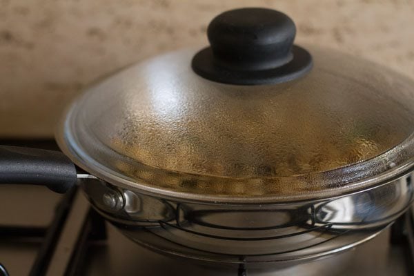 cooking sukha chana in covered pan. 