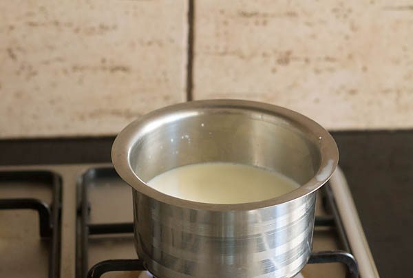heating milk in a saucepan for haldi doodh.