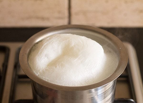 boiling milk in saucepan for haldi doodh.