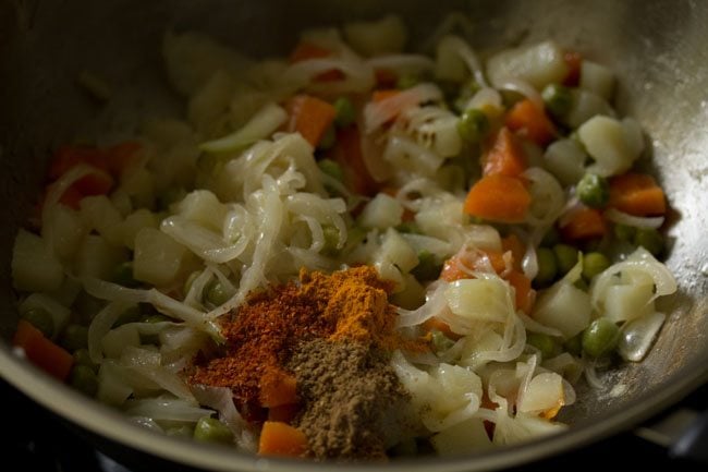 turmeric powder, red chili powder and garam masala powder added to the vegetable mixture in the kadai. 