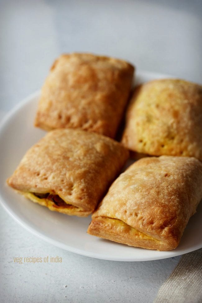 veg puffs or curry puff served on a plate. 