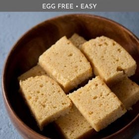 slices of wheat cake kept neatly in a wooden bowl on a light grayish blue board