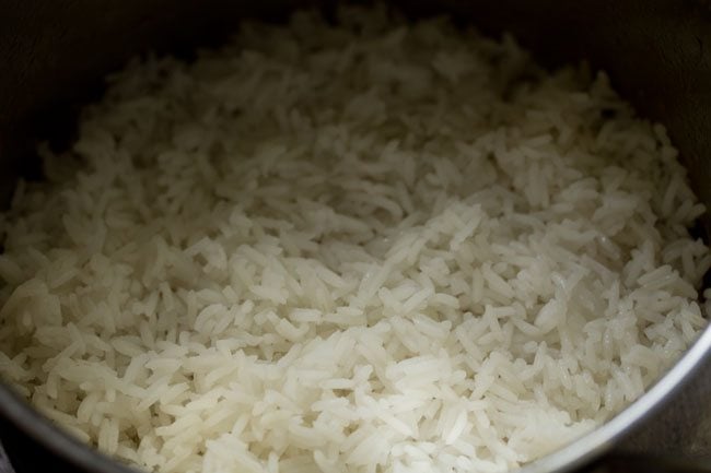 layering biryani first rice layer in the pan