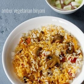 ambur biryani served on a plate with a side of vegetable salad and text layover.