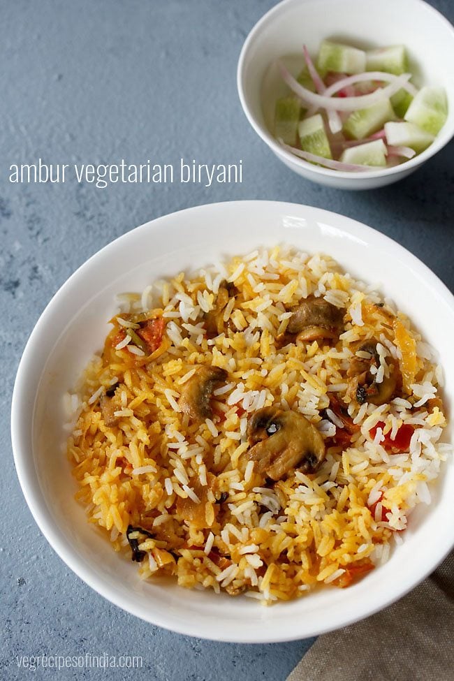 serving Ambur biryani on a plate with a side of vegetable salad