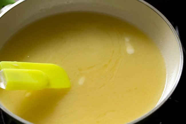 butter mixture being stirred with a green spatula